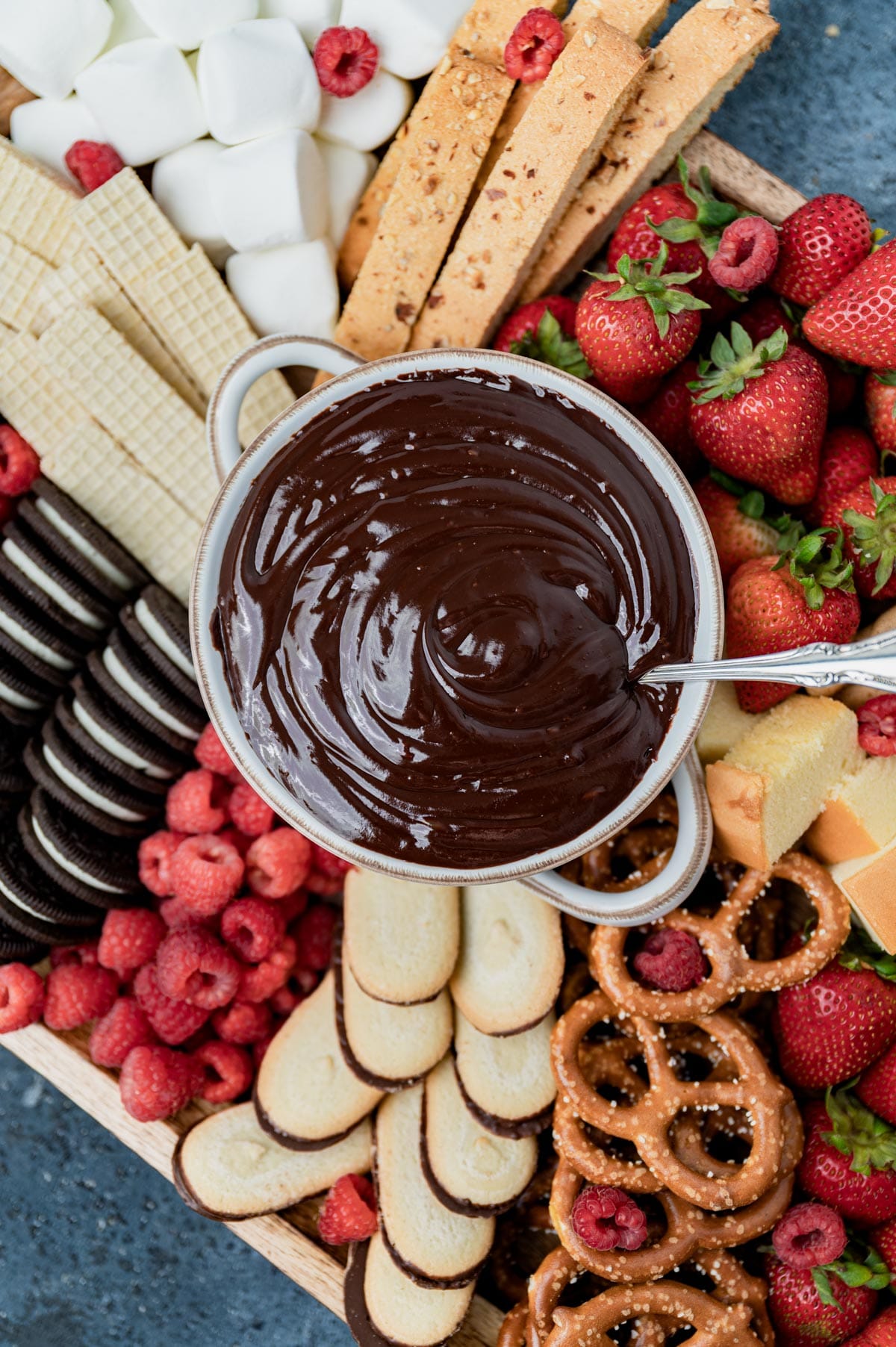 a dessert board with chocolate fondue