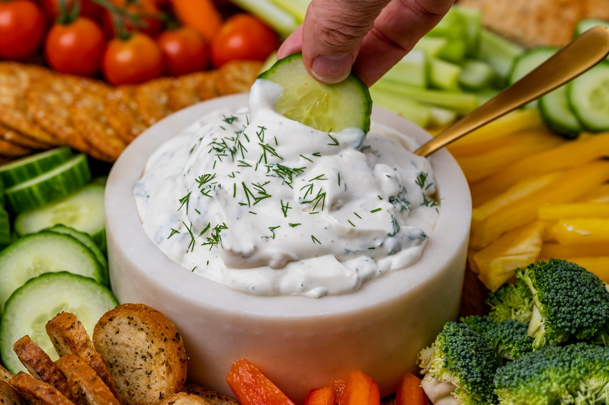 dipping cucumber in dill dip