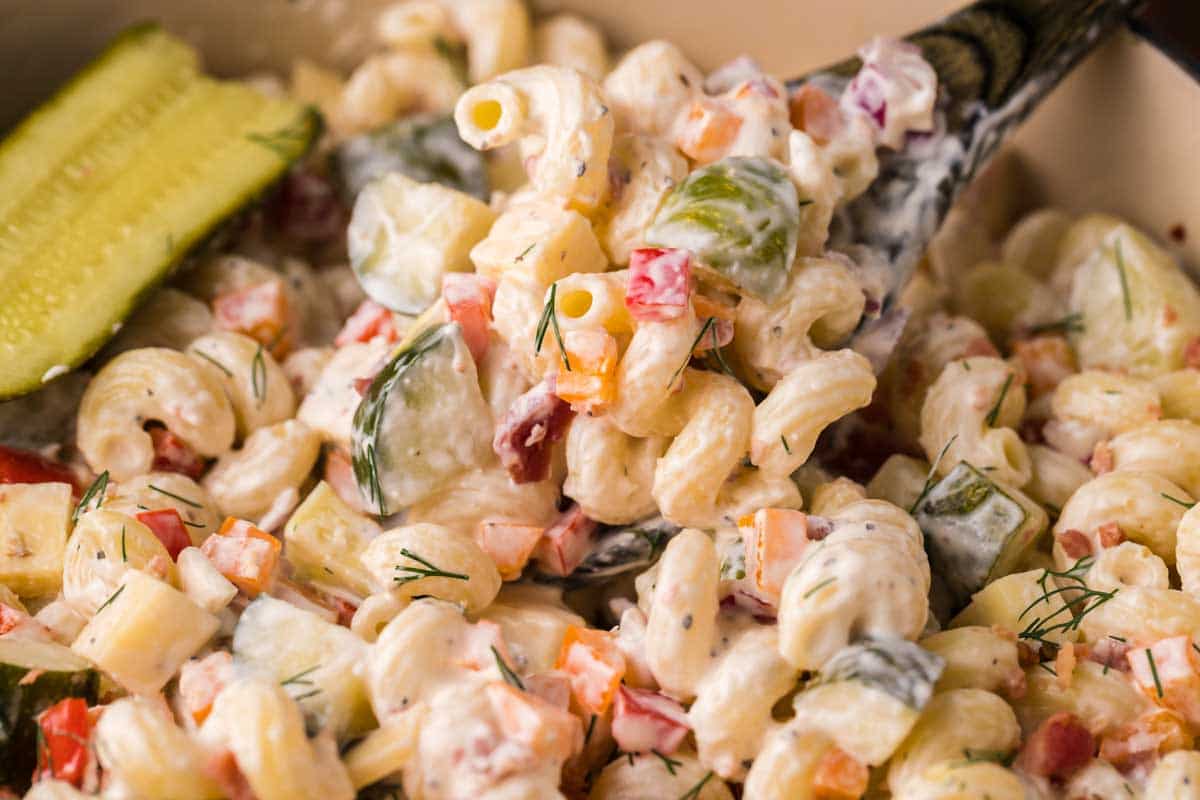 closeup of a spoonful of dill pickle pasta salad