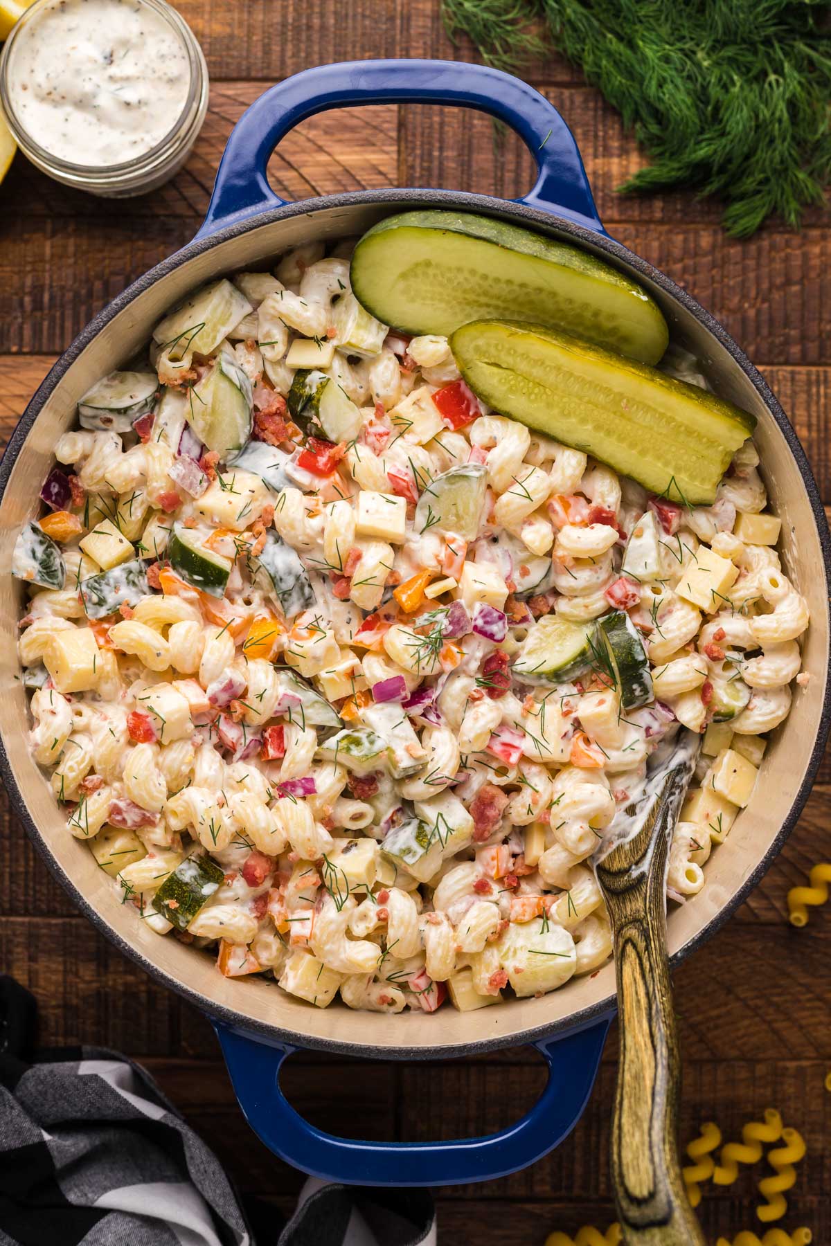 pasta salad with dill pickles in a blue pan