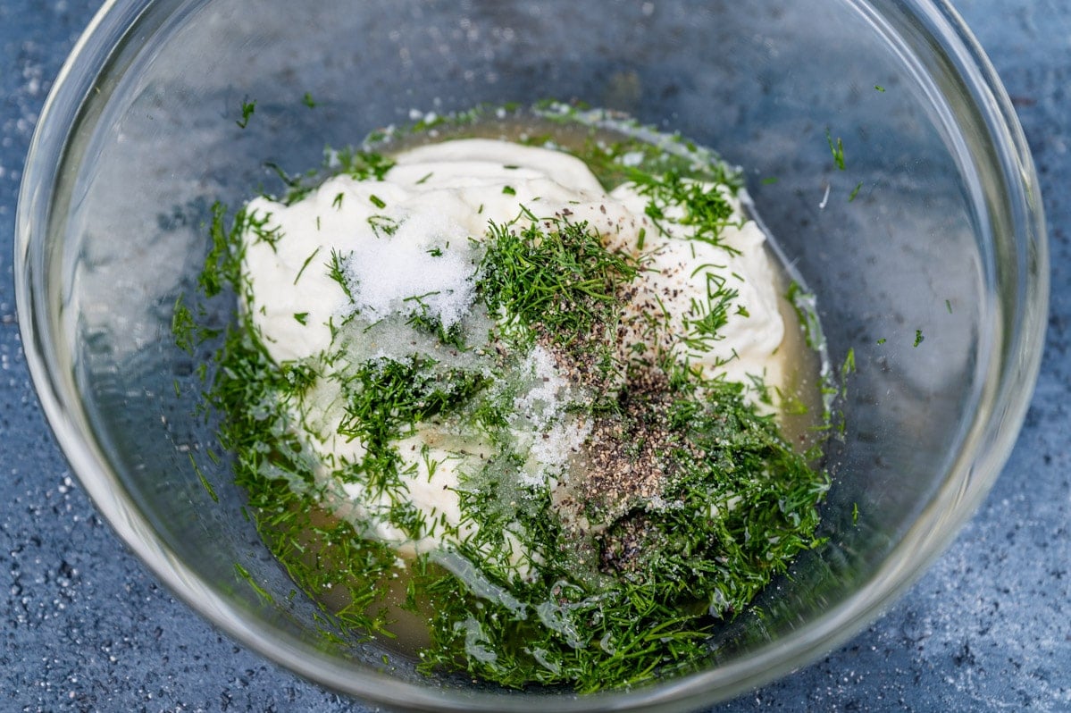 unmixed sauce for dill potato salad in a bowl