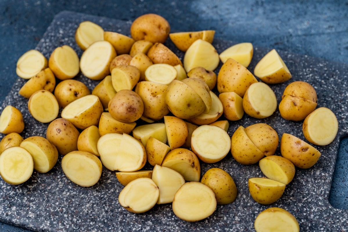 yukon gold potatoes cut in half on a cutting board