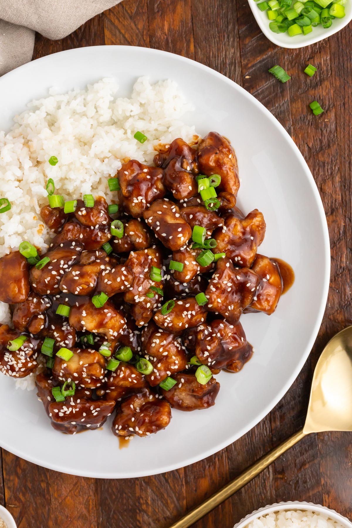 a plate of general tso's chicken and rice on a table