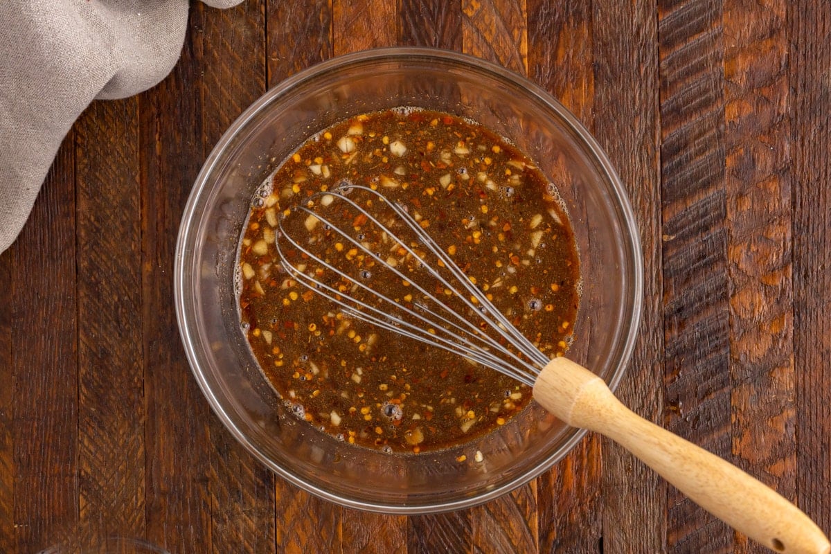 general tso's sauce in a bowl with a whisk