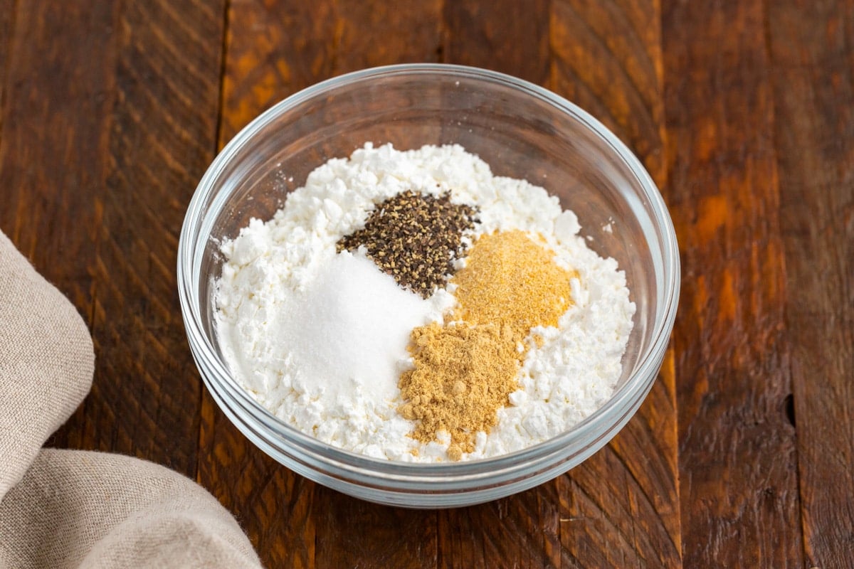flour and seasonings in a glass bowl on a table