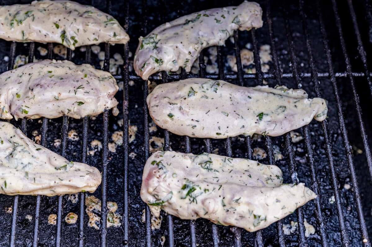 uncooked greek chicken on a grill