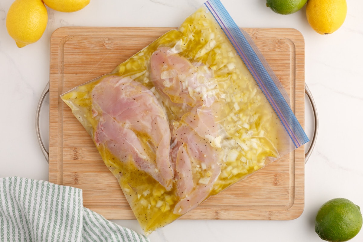 chicken breasts marinating in a plastic bag