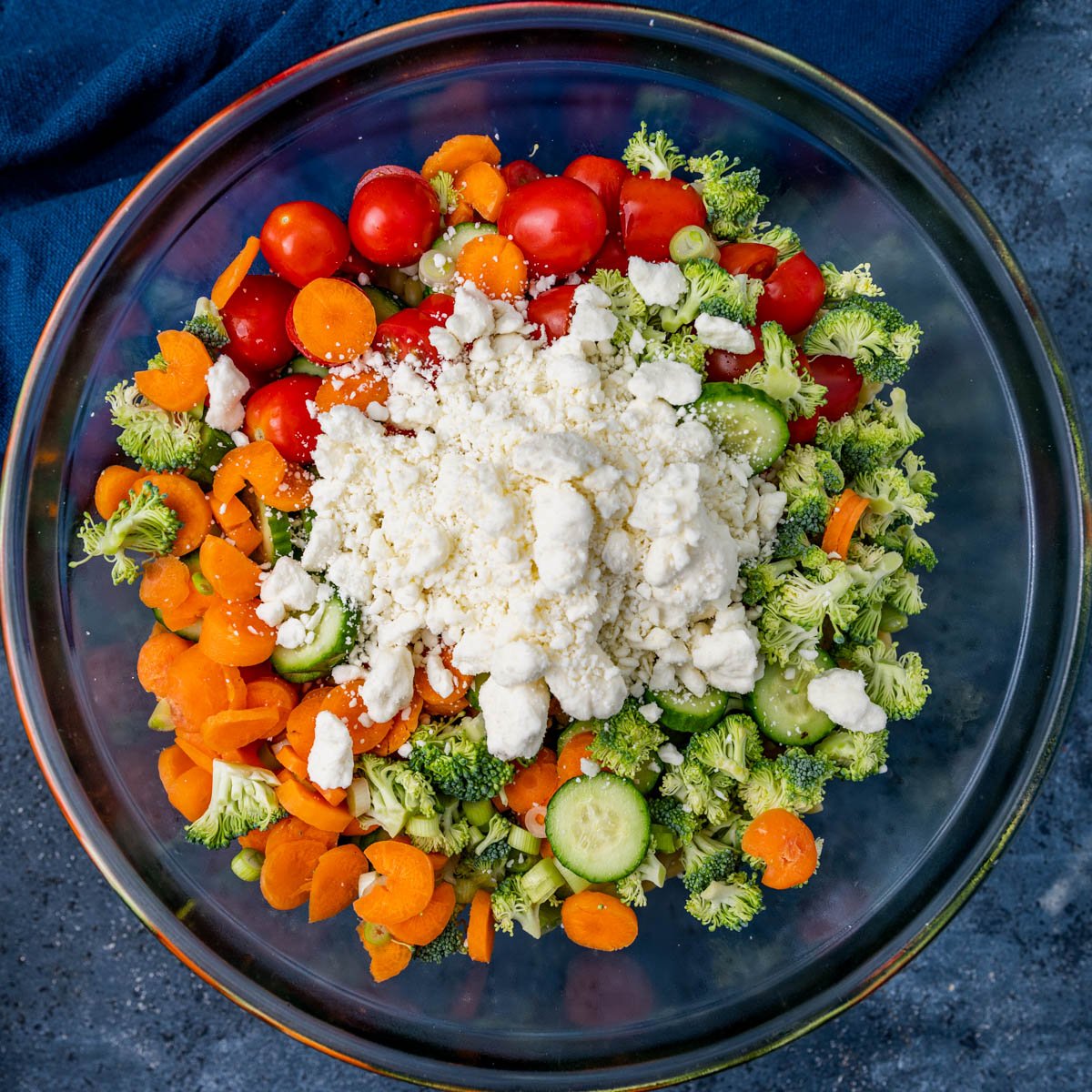 overhead view of vegetables and feta cheese in a bowl