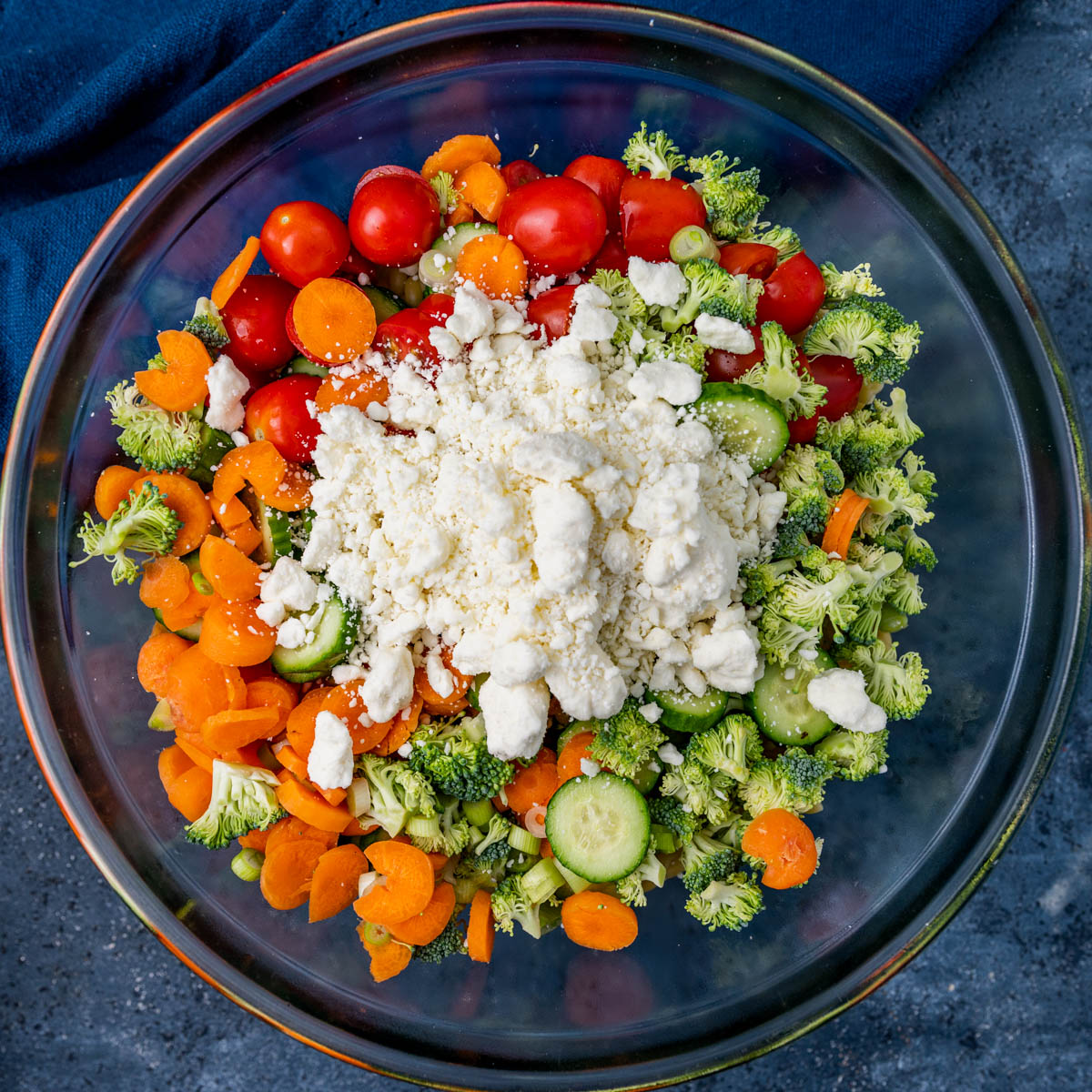 overhead view of vegetables and feta cheese in a bowl