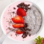 overhead view of a chia seed smoothie bowl with strawberries and chocolate