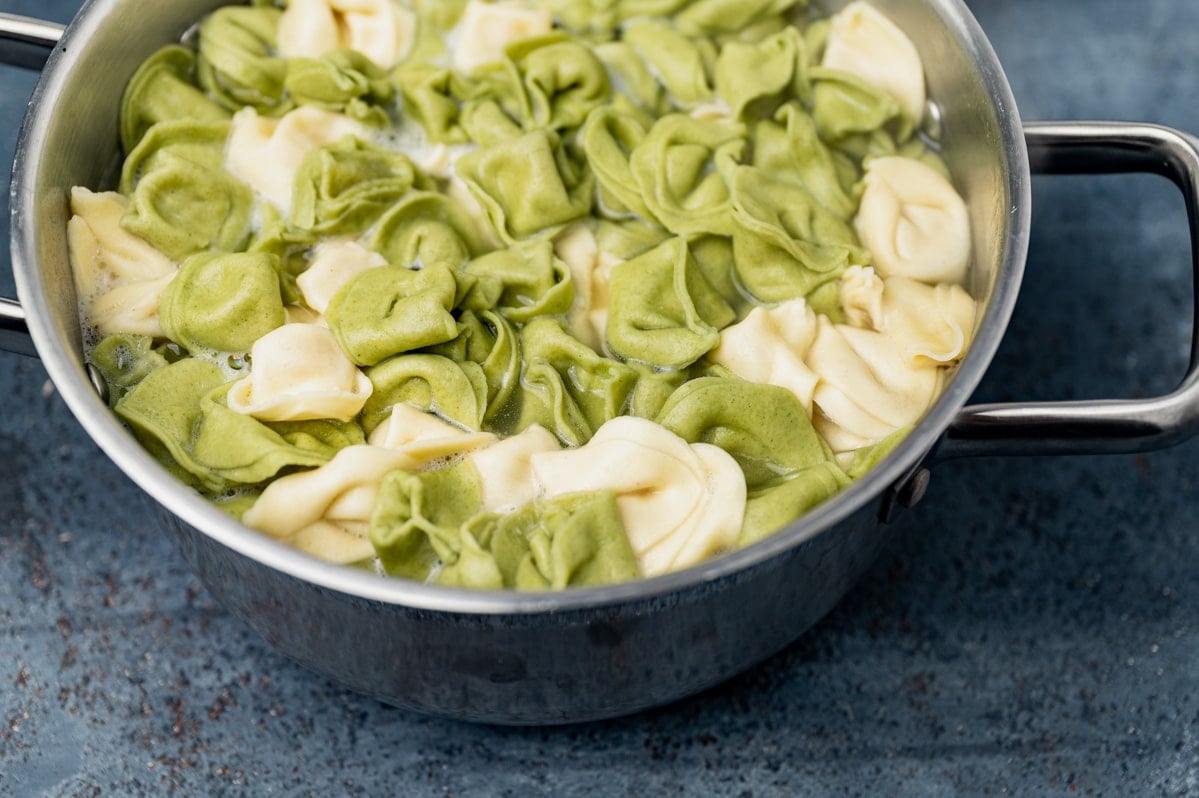 a pan of cooked tortellini pasta