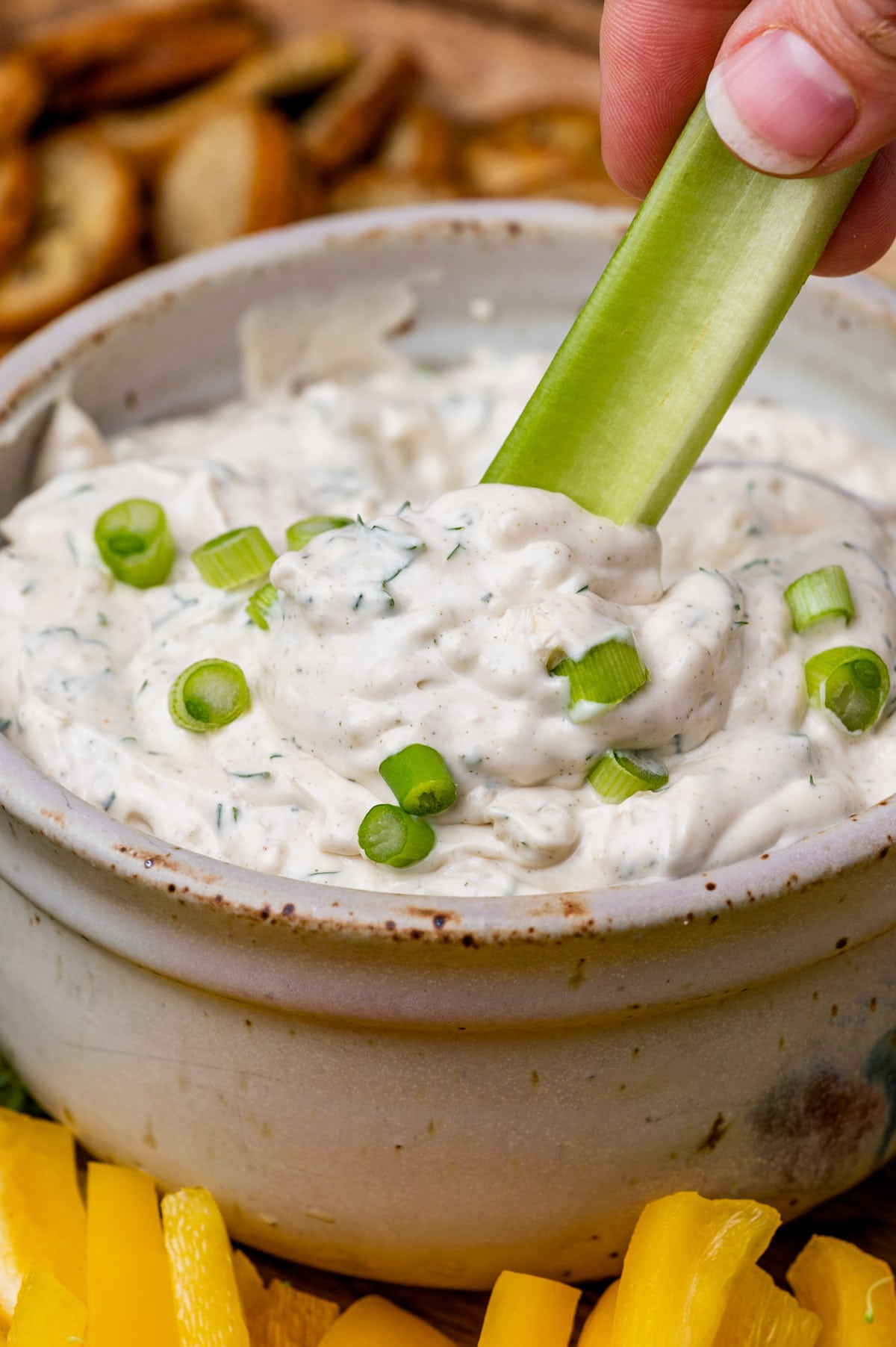 celery dipping into vegetable dip