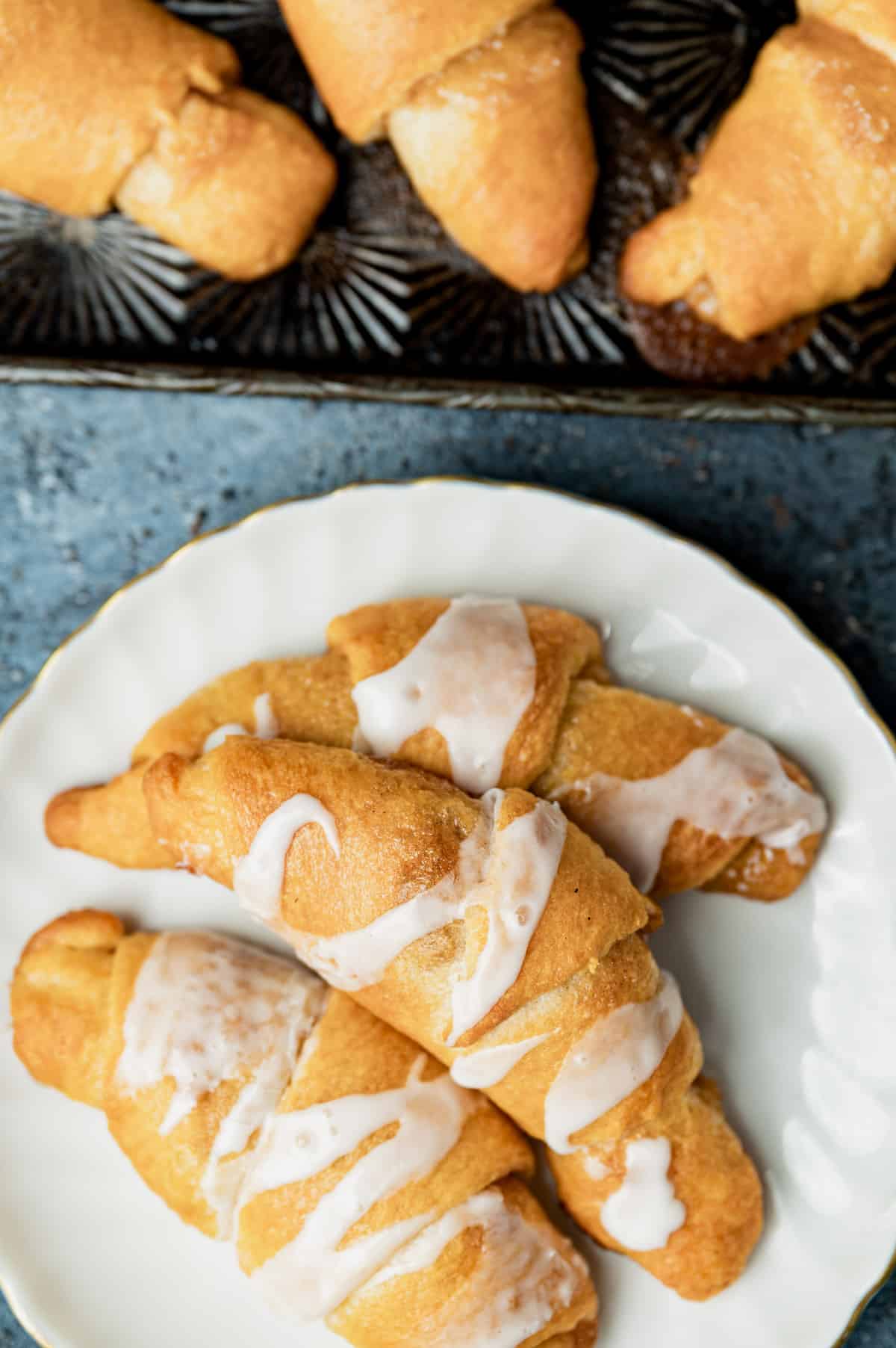 overhead view of crescent cinnamon rolls with glaze