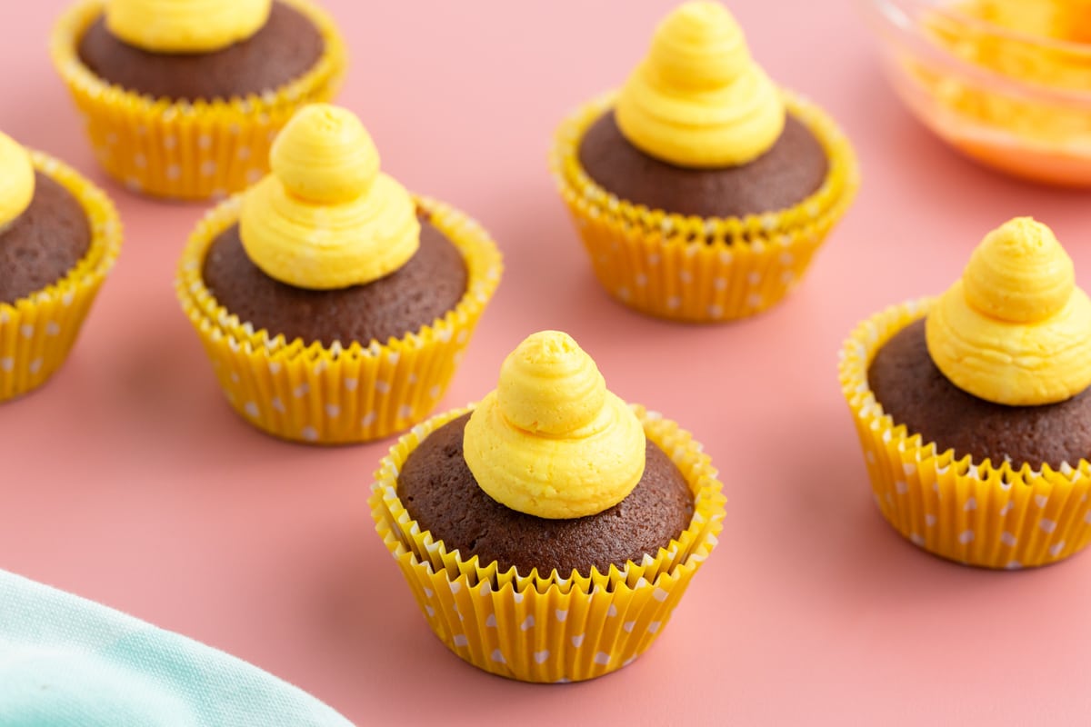 cupcakes with yellow frosting dolloped on top