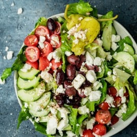 overhead view of a Greek salad bowl with homemade vinaigrette