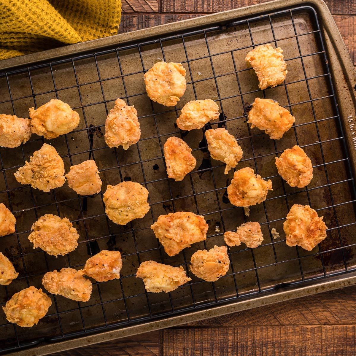 fried chicken nuggets cooling on a wire rack