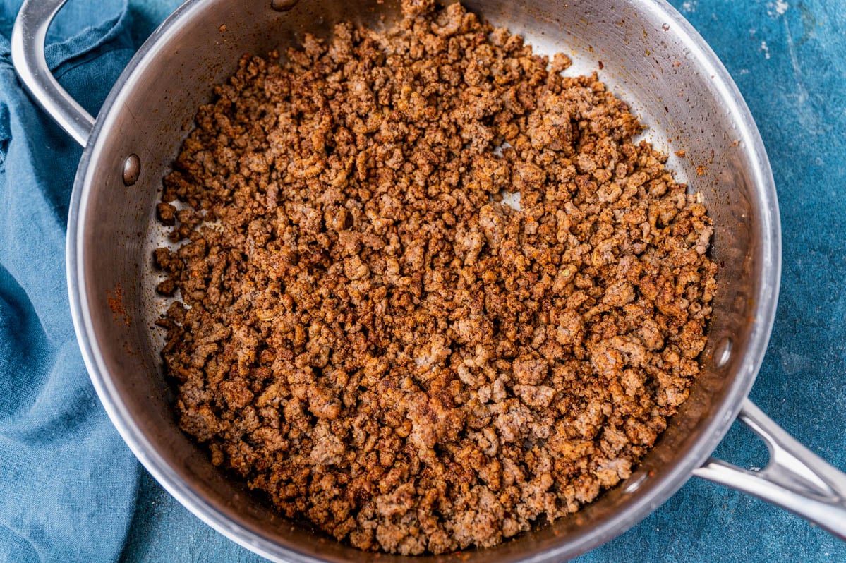 browned ground beef with taco seasoning in a frying pan