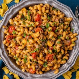 a bowl of taco pasta salad with fresh cilantro on top