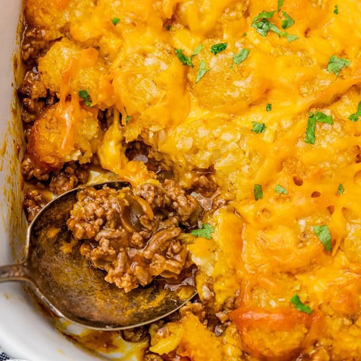overhead view of tater tot casserole with a spoon in it
