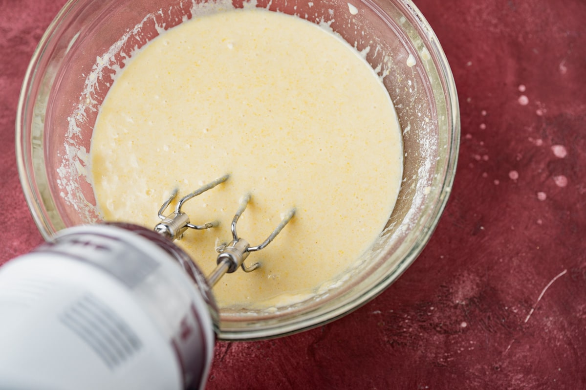 cornbread batter in a bowl with a mixer