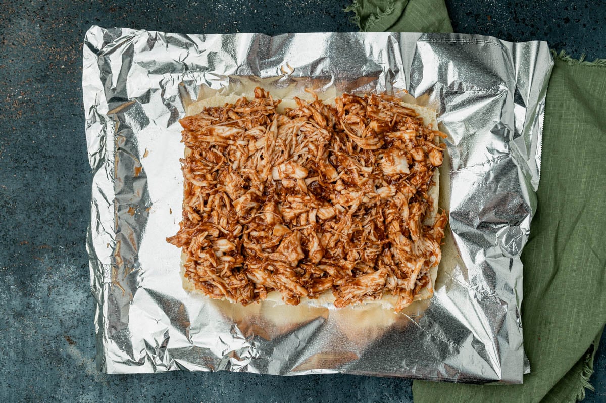 overhead view of bbq chicken on hawaiian rolls