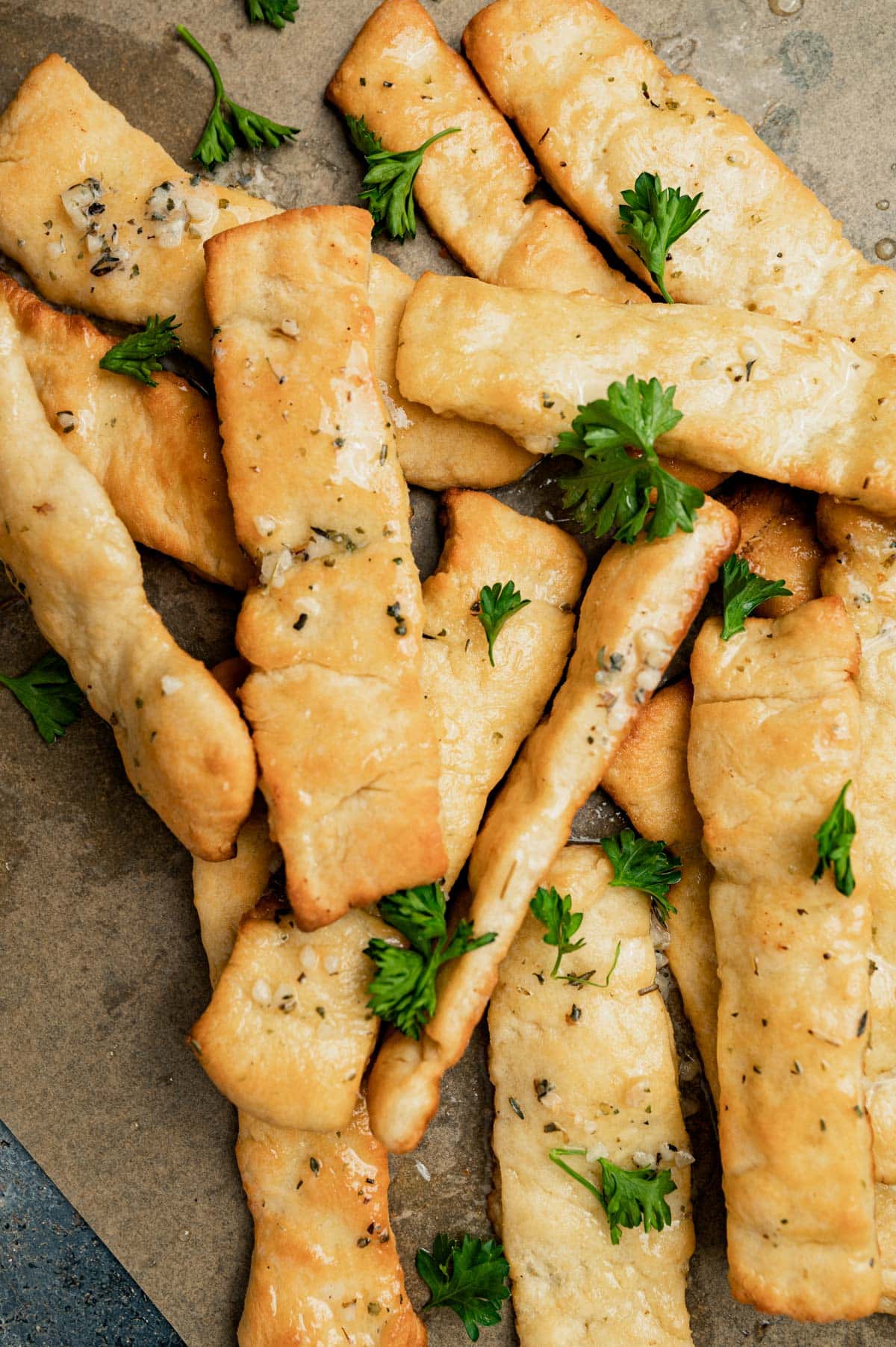 butter dips breadsticks with melted butter on a parchment paper