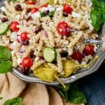 closeup of a bowl of greek pasta salad with cucumbers and tomtaotes