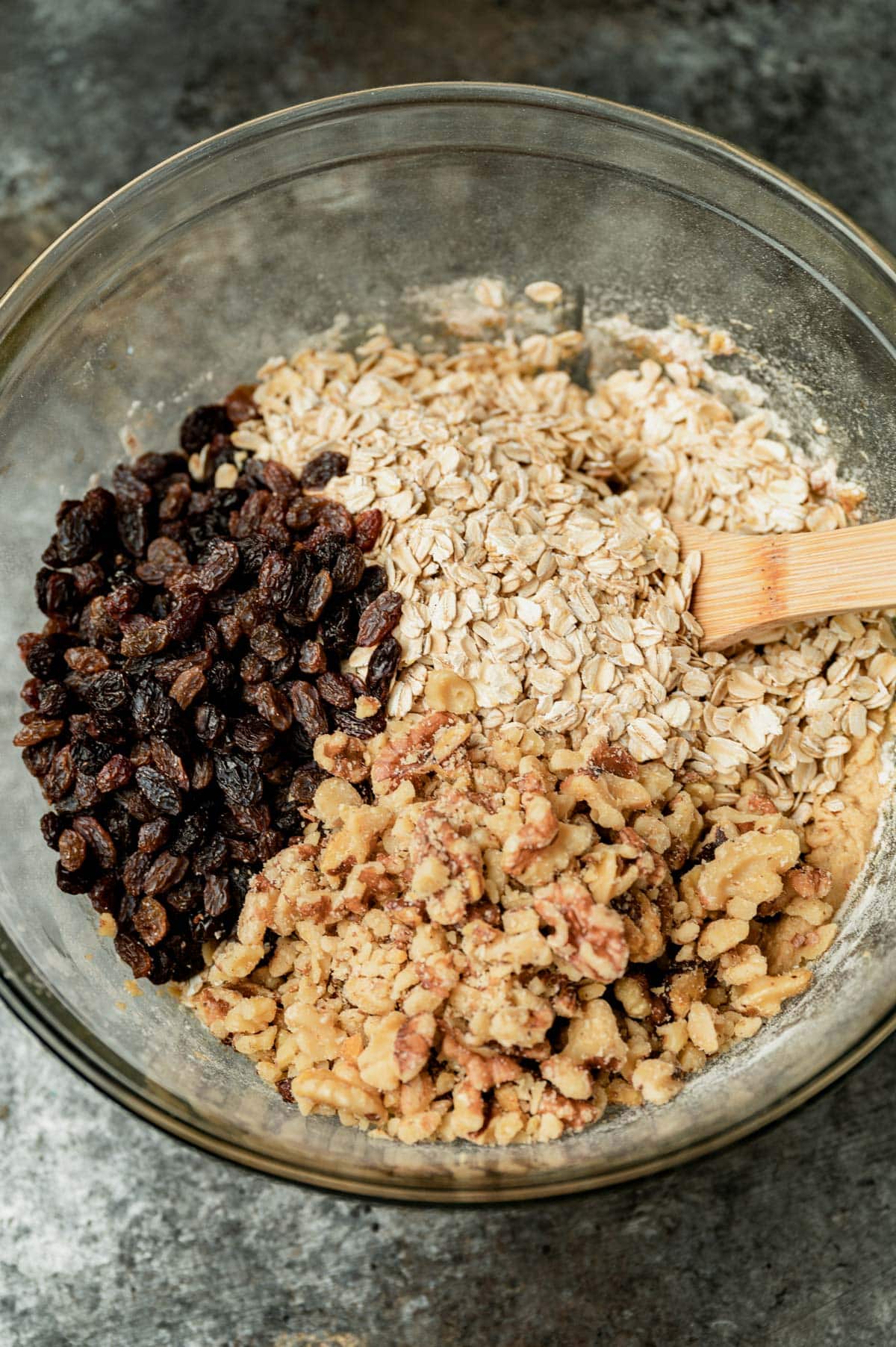 raisins, oatmeal and walnuts in a mixing bowl