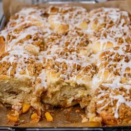 peach crumble cinnamon rolls in a pan