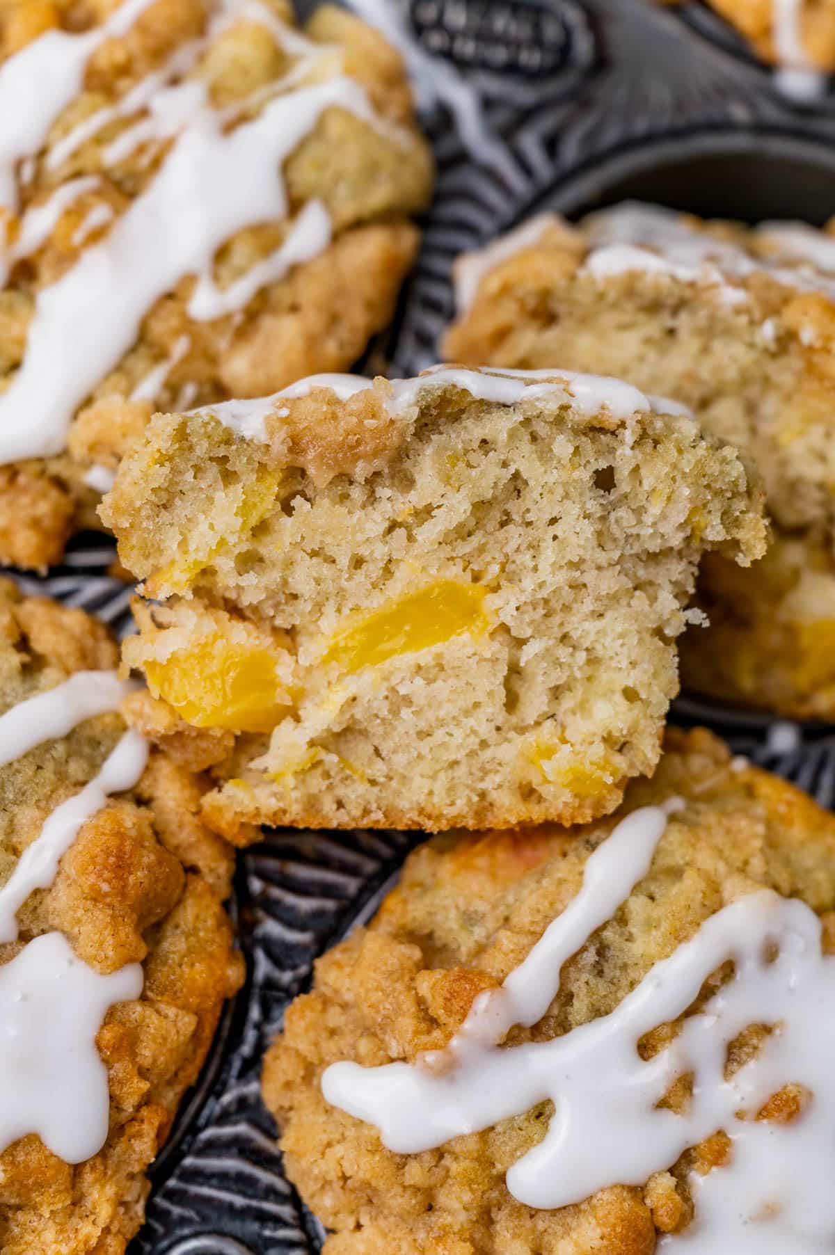 half of a peach muffin on a baking pan