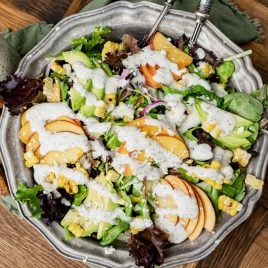 a large bowl of fresh peach salad with poppy seed dressing