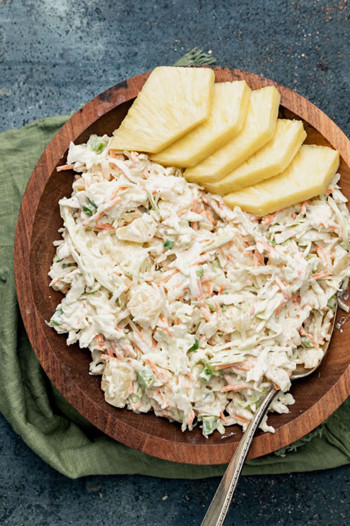 a bowl of pineapple coleslaw with pineapple slices
