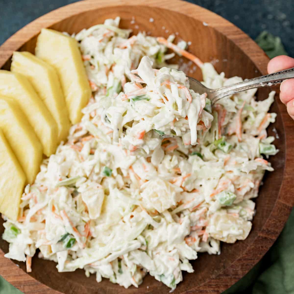 a spoonful of creamy pineapple coleslaw