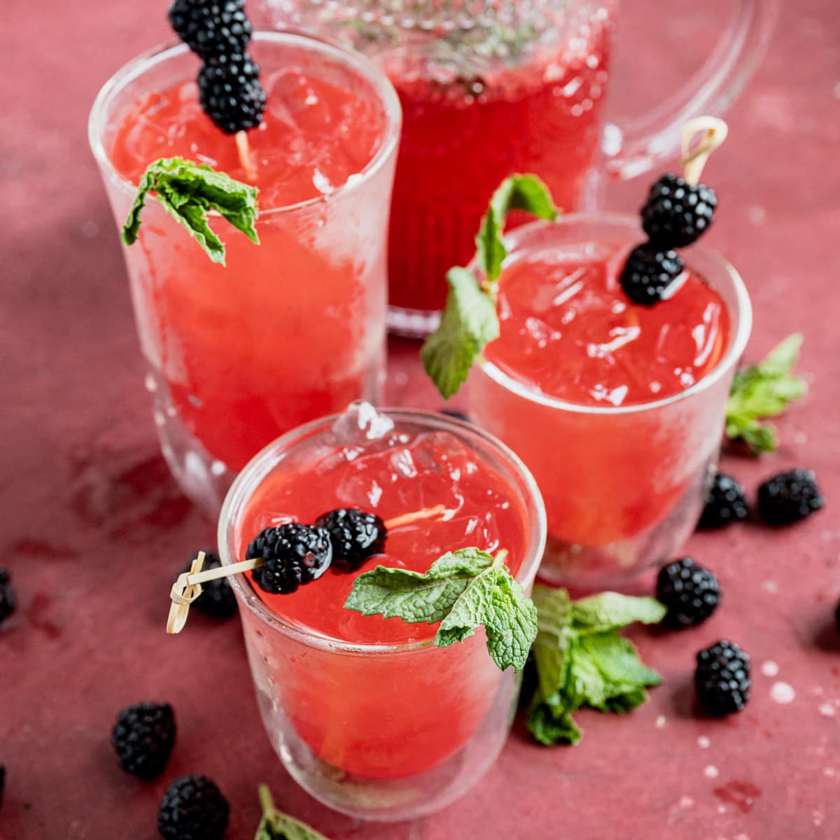 3 glasses of sparkling raspberry mint lemonade with mint and blackberries