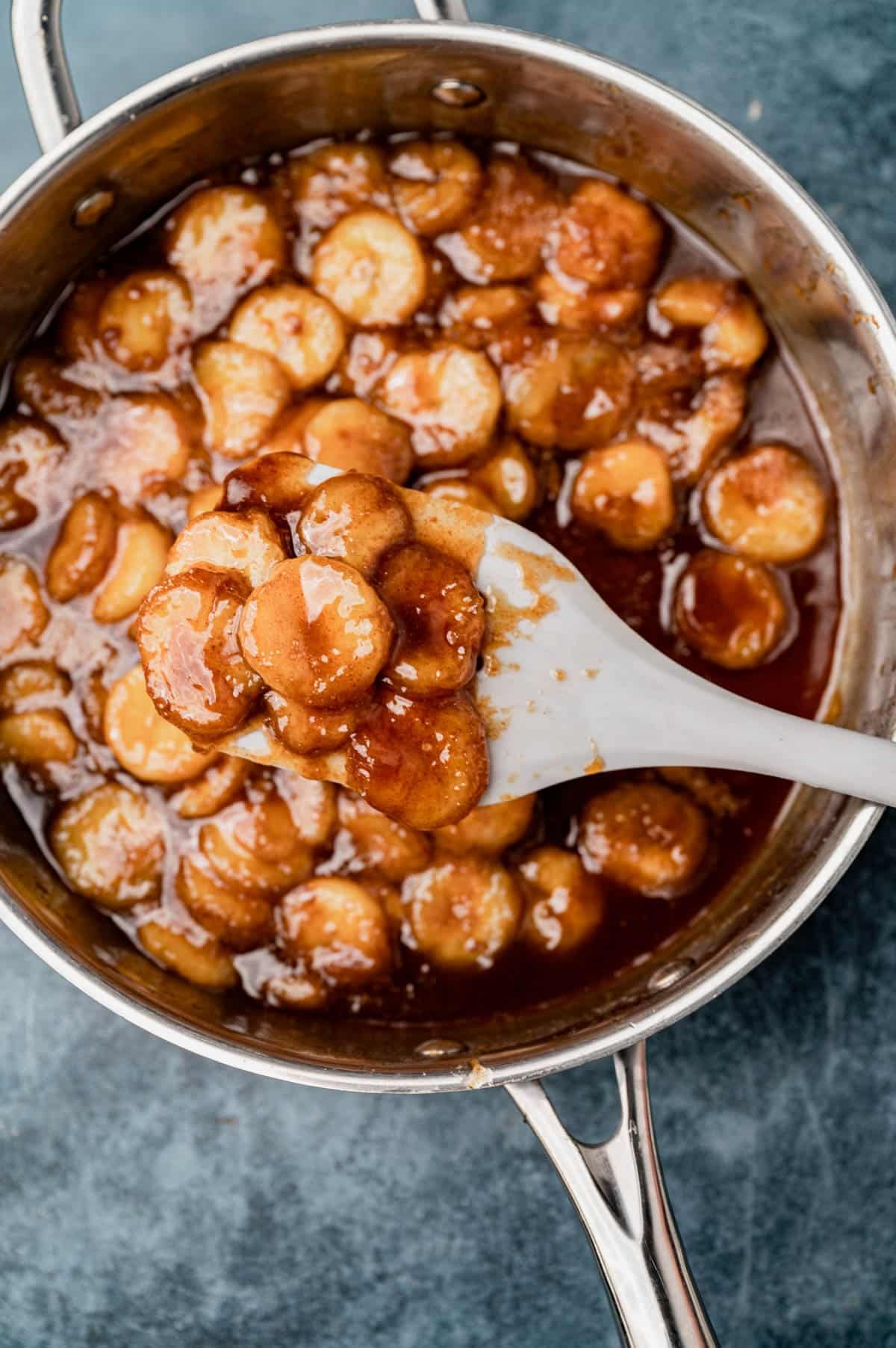 caramelized bananas on a spatula in a skillet