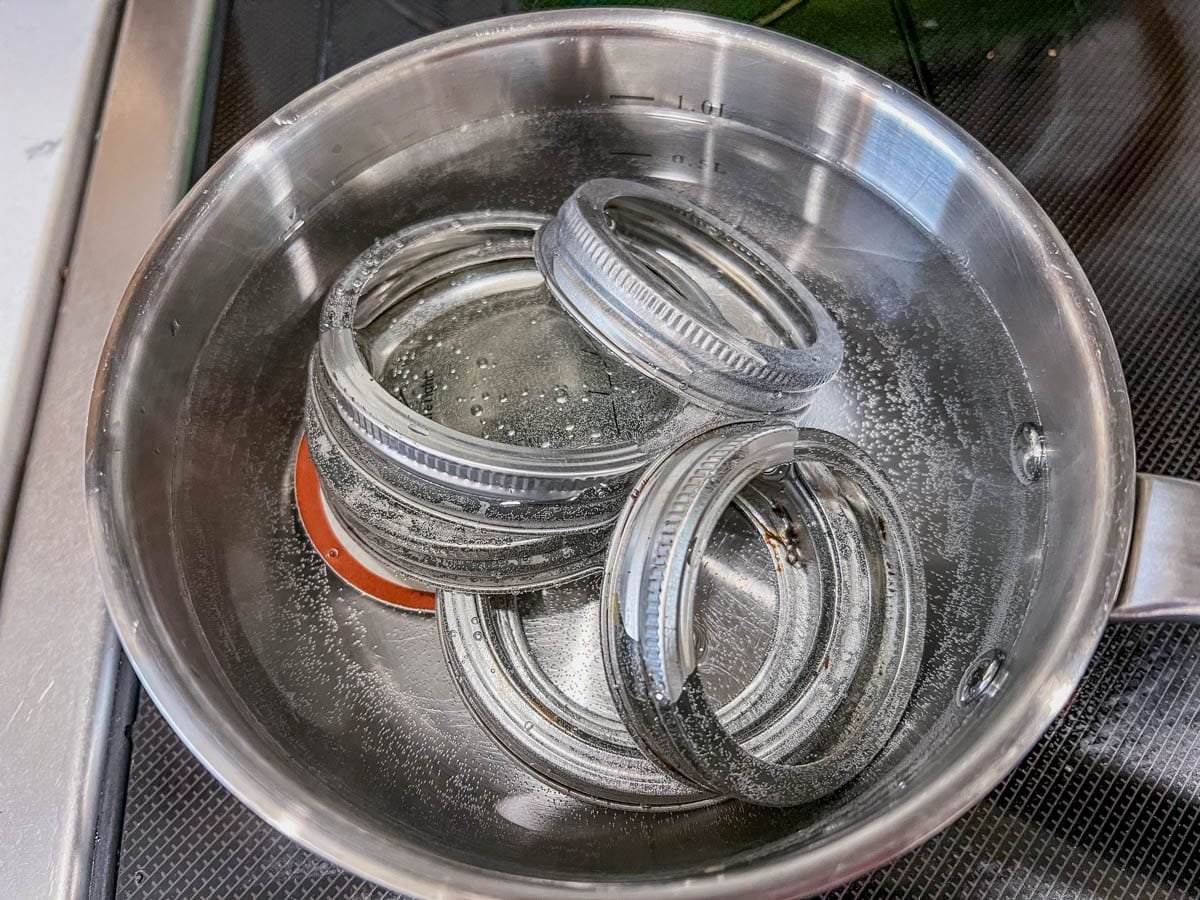 mason jar rings and lids in a pot of boiling water