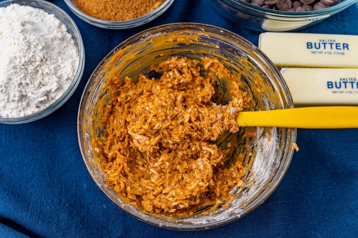 coconut, dulce de leche, flour and vanilla mixed in a bowl