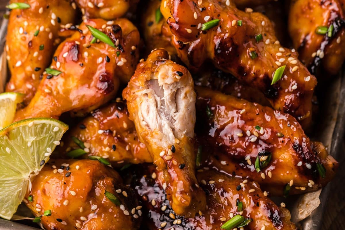 honey sriracha chicken wings with a bite out of it