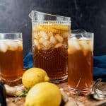 lemon ginger iced tea in a pitcher and two glasses