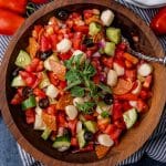 closeup of a bowl of cucumber tomato salad with pepperoni and mozzarella