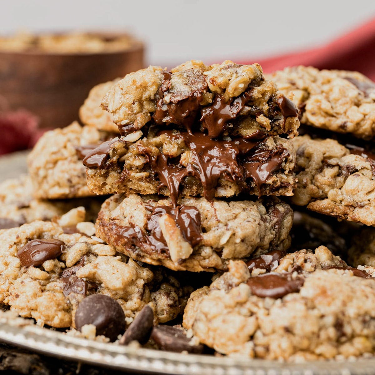a stack of Chewy Oatmeal Chocolate Chip Cookies with melted chocolate