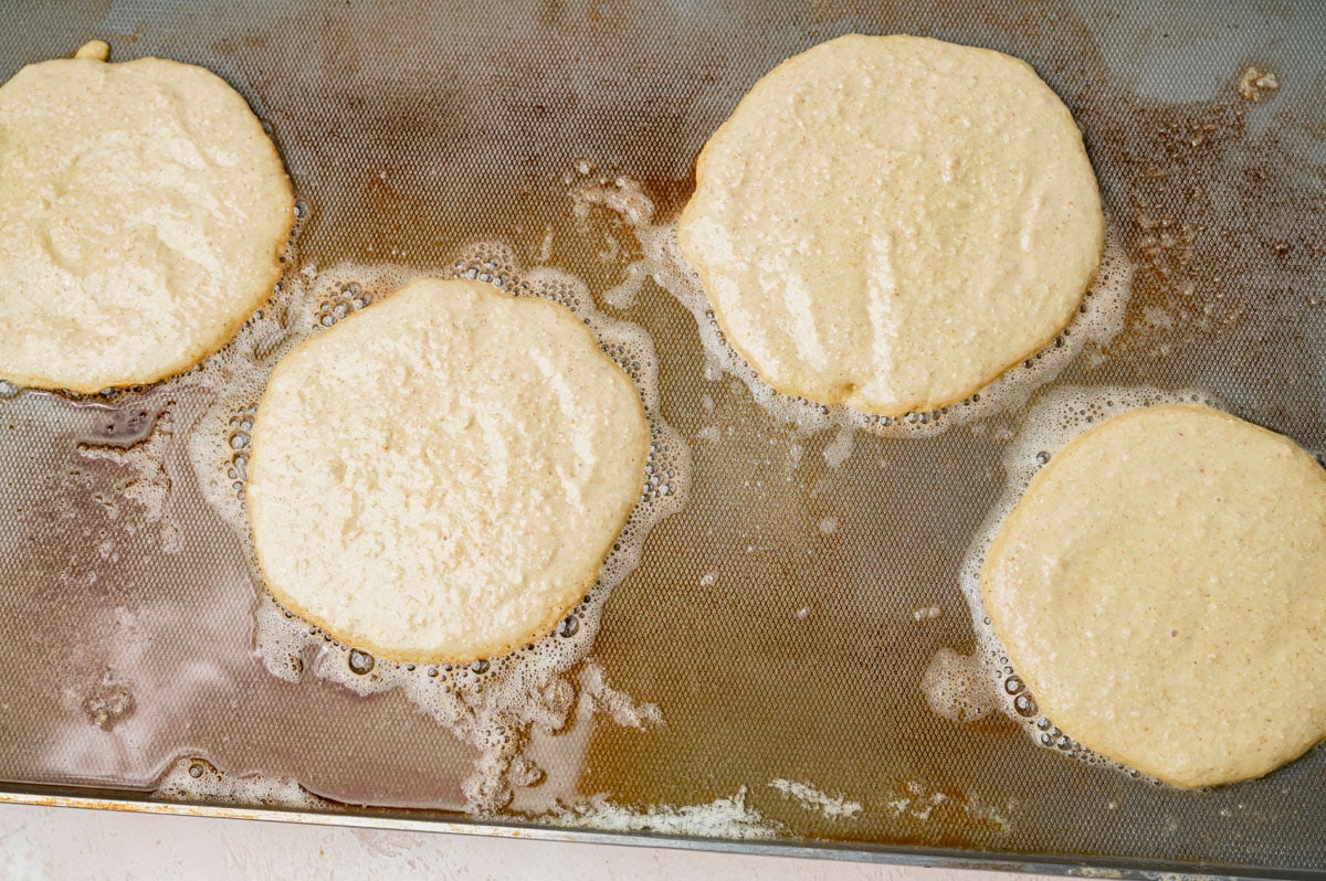 protein pancakes cooking on a griddle