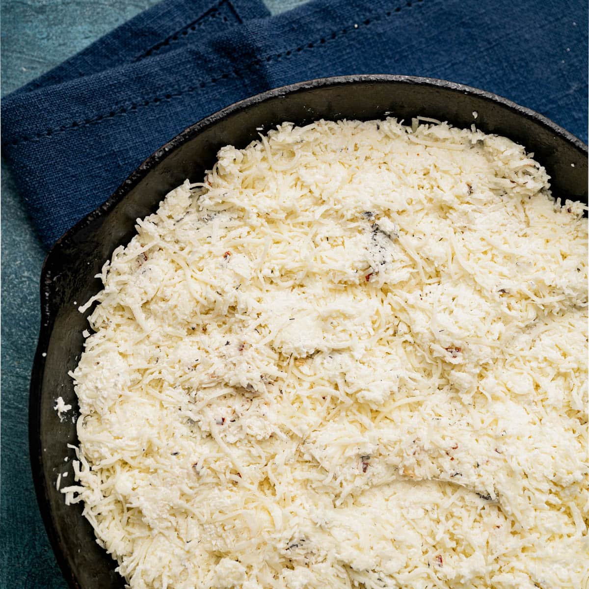 unbaked mozzarella fonduta in a pan