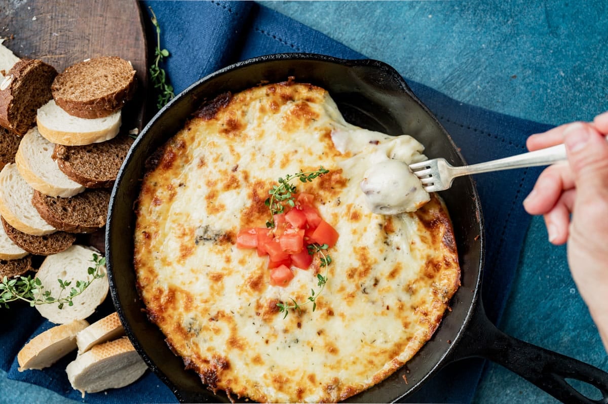 smoked mozzarella fonduta cheese dip with a fork