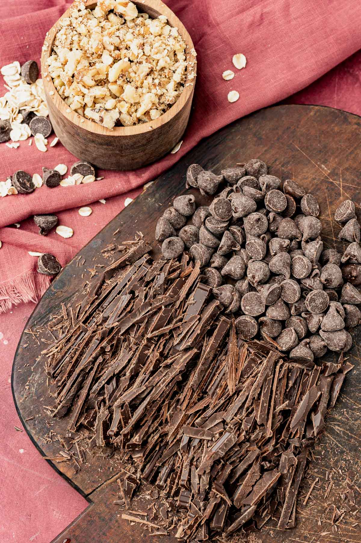 shaved chocolate, chocolate chips and chopped nuts on a table