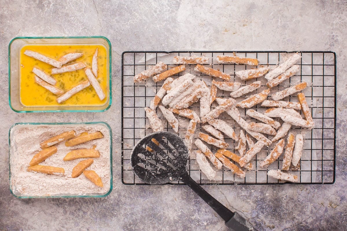 coating apple spears with egg and flour breading
