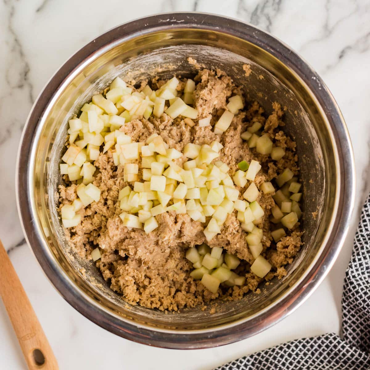 diced apples over oatmeal cookie batter