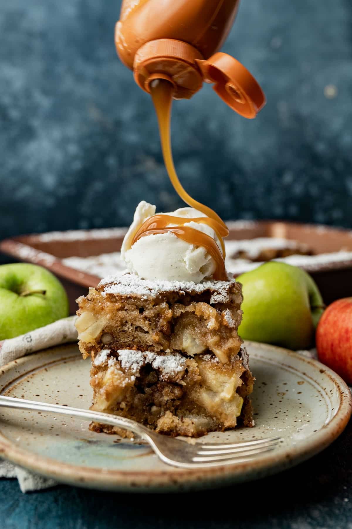 caramel drizzling over apple walnut cake