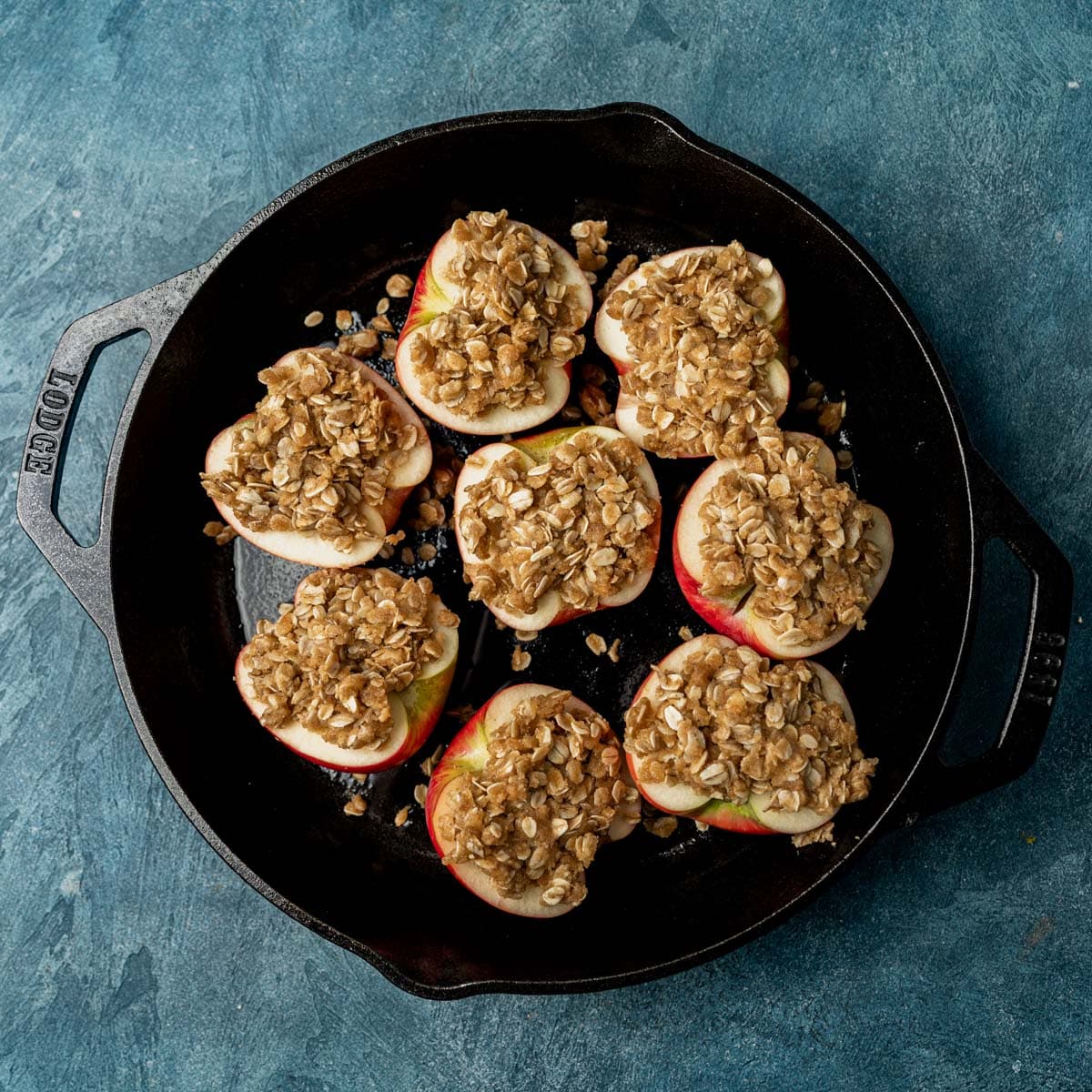 apples with oat crumble on top in a cast iron skillet