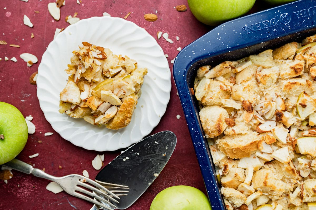 overhead view of almond apple bread pudding on a plate and in a pan